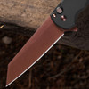 Pro-Tech Malibu BSA26.Malibu.1 shown open on a dark wood background at an angle that emphasizes the copper rose PVD blade finish. The full length of the reverse tanto blade is visible, with the copper rose PVD color appearing prominently against the black aluminum handle.
