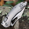 Microtech Mini Stitch RAM-LOK 169MRL-10MS1 stonewash titanium handle — RAM-LOK mechanism, bronze titanium accents, Microtech cross logo, partially open blade