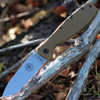 The ESEE Zancudo (BRKR2CB) shown with its 2.94-inch D2 drop point blade in a stonewash finish and flat grind, Coyote Brown polymer handle with steel frame lock, and reversible pocket clip for tip-up or tip-down carry.