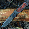 Hogue Saxum 24690-LIM open — Damascus drop point blade, matte black aluminum Kingwood handle, bronze thumb studs, Button Lock