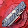 Heretic Jinn Auto H113-7A-CF spine stamp — JINN S/N serialized USA 05/2026, woven carbon fiber, bronze hardware, Button Lock auto