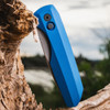 Pro-Tech Synapse 2 Vero Engineering VER2101-BLUE MM — closed, solid blue aluminum handle and DLC black machined titanium clip, outdoor background