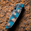Pro-Tech TR-3 Integrity Shipwreck INT1106-SHIPWRECK — open, DLC black thumb studs and pivot detail, patina copper teal relic handle
