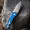 Pro-Tech Scapegoat Compact Auto RCS1105-Blue — open, push button and pivot detail, carbide textured blue aluminum handle, rock background