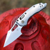 Microtech M-Stitch RAM-LOK Marfione Select 169MRL-10MS4 open front view — 3.05" M390MK stonewash spear point blade, slab-side titanium handle with flamed titanium accent, bronzed vapor blast hardware