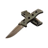 A Benchmade Adamas folding knife shown with the blade deployed alongside its tan ballistic nylon MALICE Clip sheath, highlighting the MagnaCut Flat Dark Earth Cerakote partially serrated drop-point blade and OD Green G10 handle.