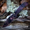 The Microtech LUDT Gen III (1136S-1TPBKPKCS) shown with its 3.4-inch M390 tanto blade in a Topographic Black/Pink Camo finish, matching Topographic Black/Pink Camo aluminum handle with black Torx hardware, and its tip-up right carry pocket clip. The push button opener and plunge lock are visible on this automatic folder. ⚠️ This is an automatic knife — verify legal status in your jurisdiction before purchasing.