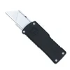 The CobraTec OTF Utility Knife (CTOTFUTBLK) shown with its dual action OTF mechanism, standard replaceable utility blade, black anodized 6061-T6 aluminum handle, and its right-hand carry pocket clip. The spring-loaded blade lock arrow used for blade changes is visible on the carrier. ⚠️ This is an OTF automatic knife — verify legal status in your jurisdiction before purchasing.