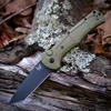 The Benchmade Claymore Auto (9071BK-03) shown with its 3.60-inch 154CM plain edge tanto blade in a Cobalt Black finish and flat grind, Ranger Green Grivory handle with deeply molded texture, and its reversible deep-carry tip-up pocket clip. The push button with integrated safety lock is visible on this automatic knife. ⚠️ Verify legal status in your jurisdiction before purchasing.
