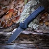 The Benchmade Claymore Auto (9070SBK-02) shown with its 3.60-inch 154CM combo edge drop point blade in a Cobalt Black finish, Black Grivory handle with deeply molded texture, and its reversible deep-carry tip-up pocket clip. The push button with integrated safety lock is visible on this automatic knife. ⚠️ Verify legal status in your jurisdiction before purchasing.