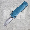 The Hogue Micro Counterstrike (34703) automatic OTF knife shown with its 1.95-inch double edge CPM-MagnaCut blade in a stone tumbled finish, ornately milled 6061-T6 anodized aluminum case, Slate Blue glass fiber reinforced polymer cover, and deep carry reversible pocket clip.