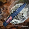 Hogue Saxum 24676 open, black Cerakote drop point blade, matte black aluminum handle with kingwood insert