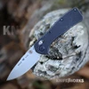 The Buck Mini Range Trail Worn Elite 0790BKS2 is shown open, featuring a stonewashed CPM MagnaCut drop point blade, crossbar lock, and tumbled black aluminum handle with a deep-carry pocket clip.