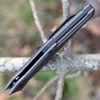 Kershaw 7900GRYBLK Launch 7 showing the integrated backspacer and bullseye firing button.