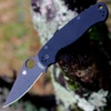 The Spyderco Para Military 2 C81GPBK2 is shown open against a white background. The black DLC-coated clip point blade with a Trademark Round Hole extends from a black textured G-10 handle.