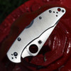 Stainless steel Spyderco Delica 4 showing the partially serrated VG-10 blade.