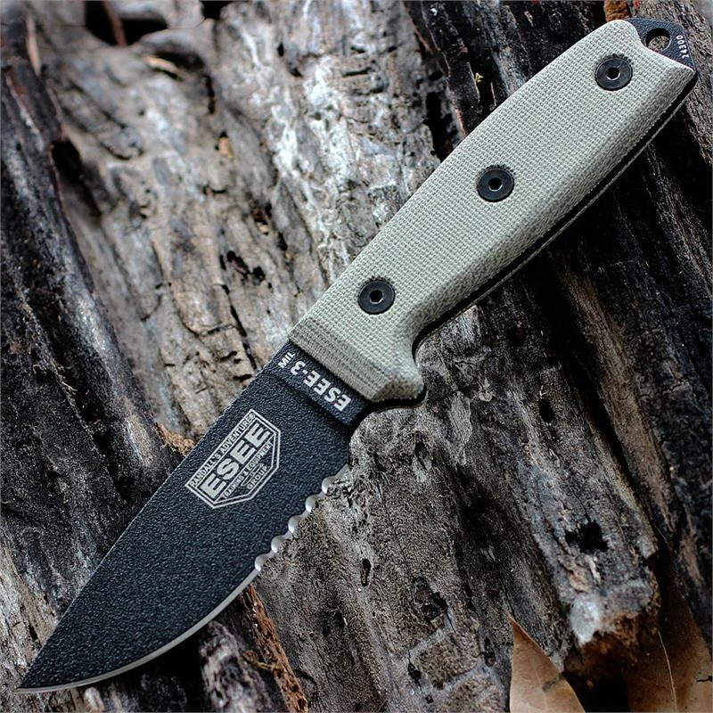 The ESEE-3MIL (ESEE-3MIL-S-B) shown with its 3.88-inch 1095 black part serrated drop point blade and flat grind, tan Micarta handle with integrated glass breaker, and its injection-molded black plastic sheath with black MOLLE back mounting.