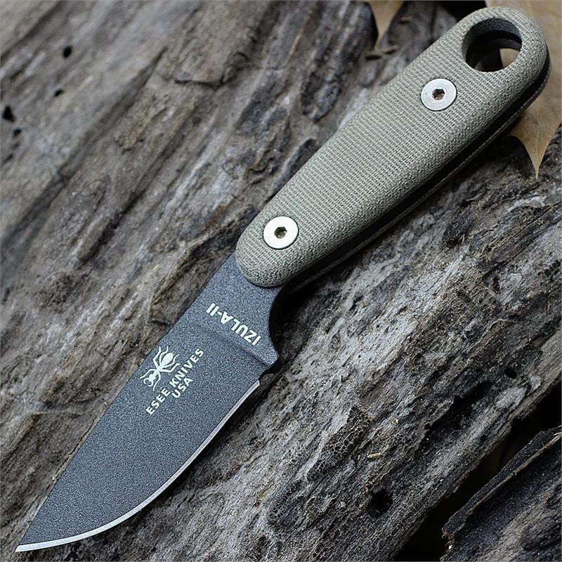 The ESEE Izula II Survival Kit (IZULA-II-TG-KIT) shown with its 2.63-inch 1095 plain edge drop point blade in a Tactical Gray finish and flat grind, tan Micarta handle, black polymer sheath, and the full kit: paracord, cord lock, split rings, ferro rod, whistle, and snap hook.