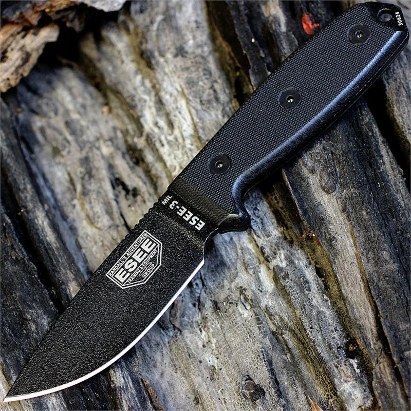 The ESEE-3MIL (ESEE-3MIL-P-BLK) shown with its 3.88-inch 1095 black plain edge drop point blade and flat grind, black G-10 handle with integrated glass breaker, and its injection-molded black plastic sheath with black MOLLE back mounting.