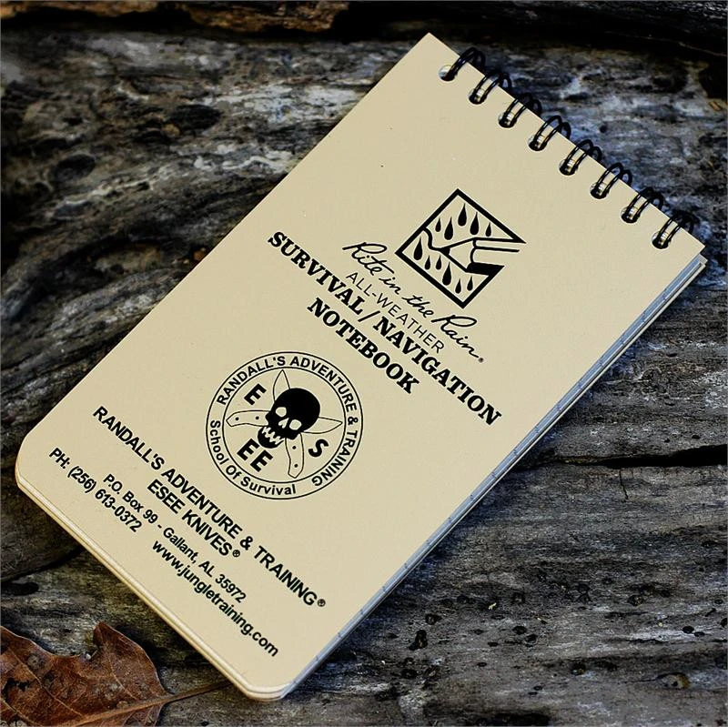 The ESEE Rite in the Rain Survival/Navigation Notepad (ESEE-RIR-NOTEBOOK), a 3" x 5" spiral-bound notepad with 45 pages of Rite in the Rain paper, land navigation and survival information, and clear map scale and compass cards.