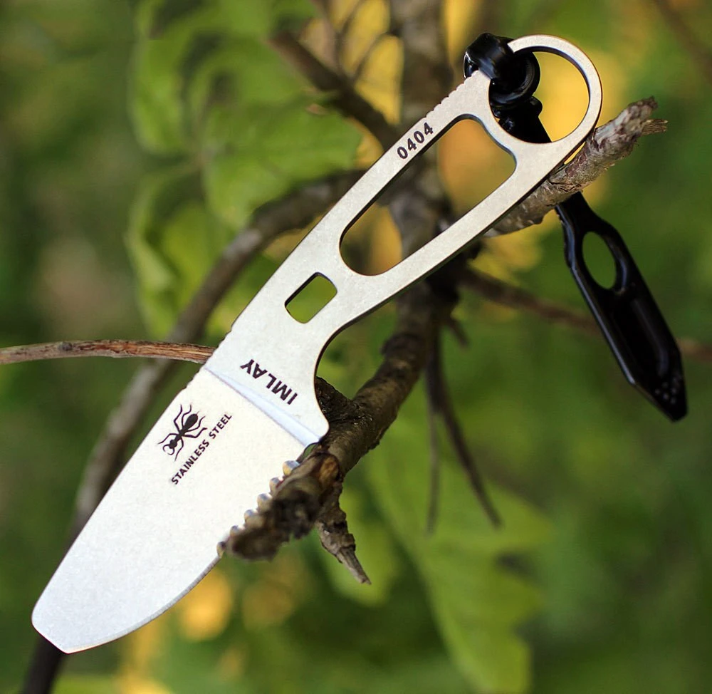The ESEE Imlay Rescue (ESEE-IMLAY) shown with its 2.25-inch 440C partially serrated blunt tip blade in a stonewash finish and flat grind, gray skeletonized stainless steel handle, and its black polymer sheath with rubber retention strap and integrated oxygen wrench.