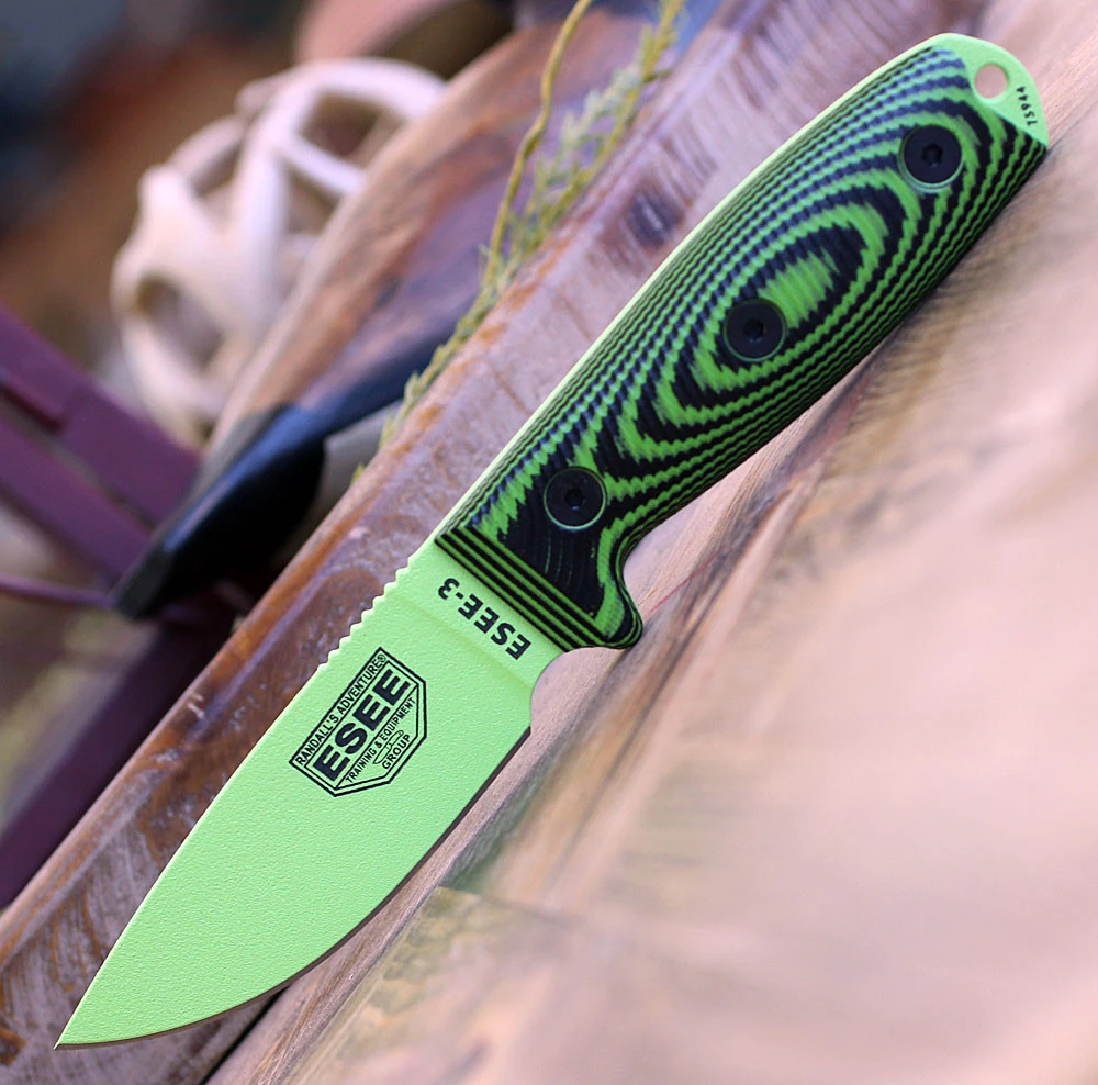The ESEE-3 3D Handle (ESEE-3PMVG-007) shown with its 3.875-inch 1095 drop point blade in a Venom Green finish and flat grind, 3D black/neon green G-10 handle scales, and its injection-molded black polymer sheath.