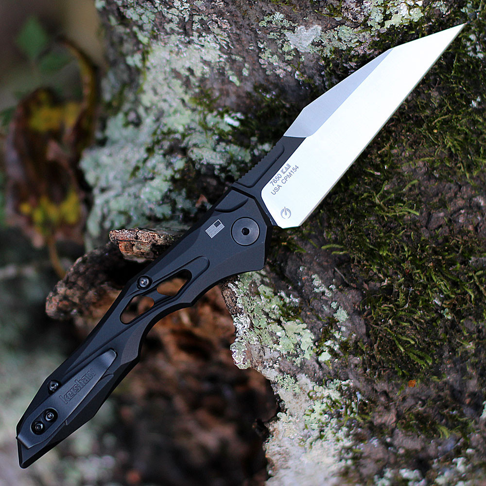 Kershaw Launch 13 being deployed via push button showing the integrated lanyard hole and slim deep-carry clip.