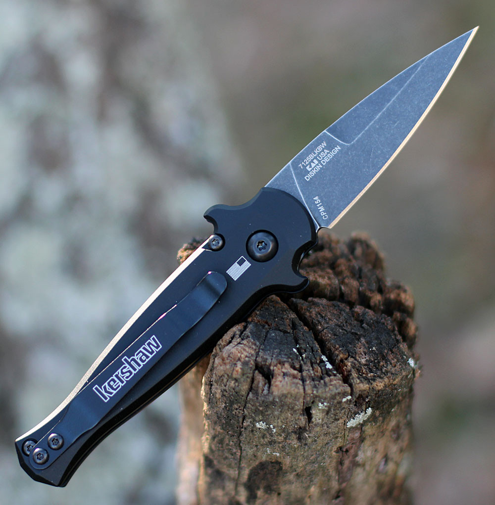 Kershaw Launch 12 being deployed via push button showing the integrated finger guards and deep-carry pocket clip.