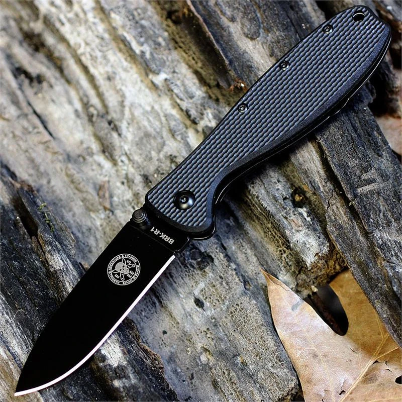 The ESEE Zancudo (BRKR1B) shown with its 2.94-inch AUS-8 drop point blade in a black finish and flat grind, black polymer handle with steel frame lock, and reversible pocket clip for tip-up or tip-down carry.