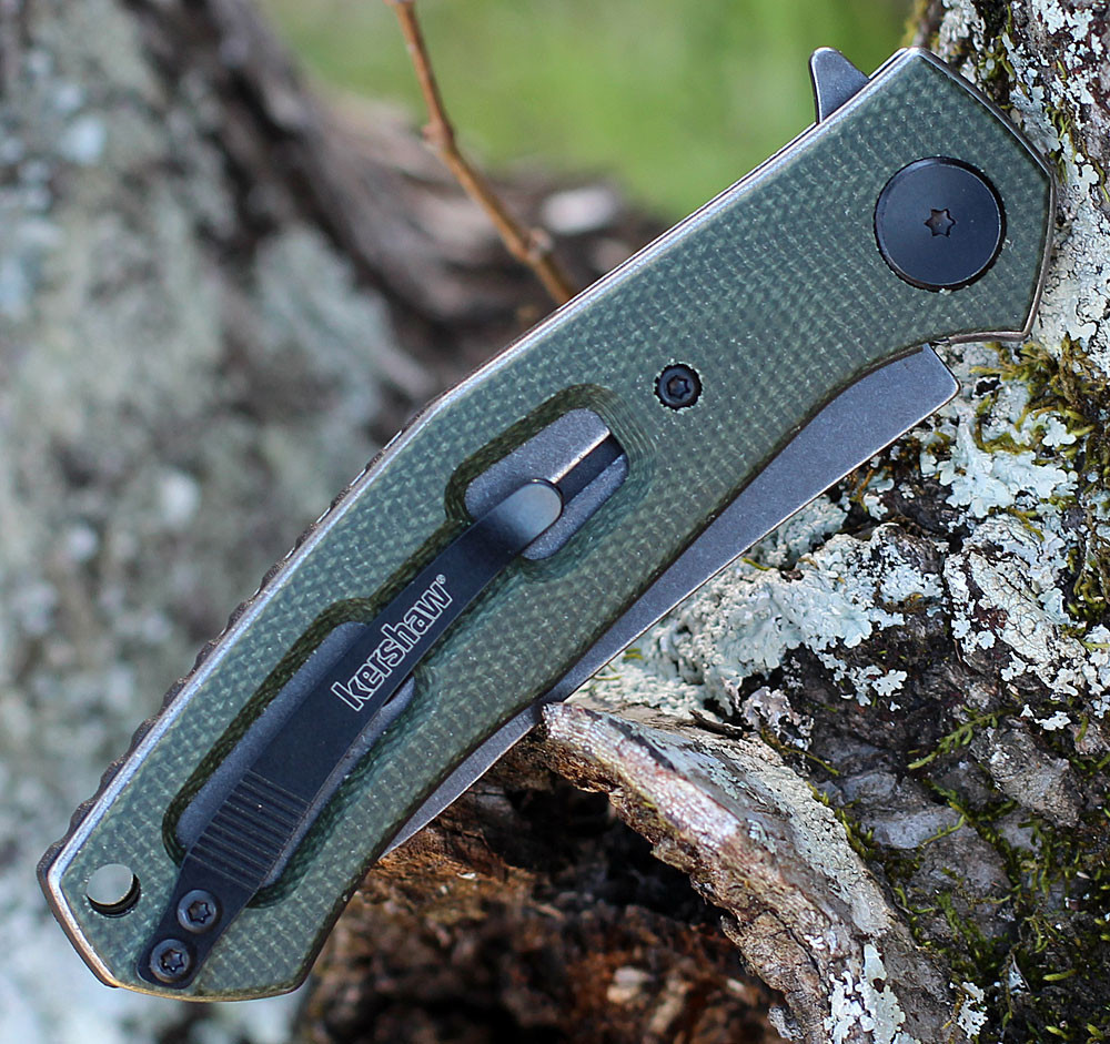 Kershaw 4020MCG Concierge highlighting the green canvas micarta scales and custom shield pivot detail.