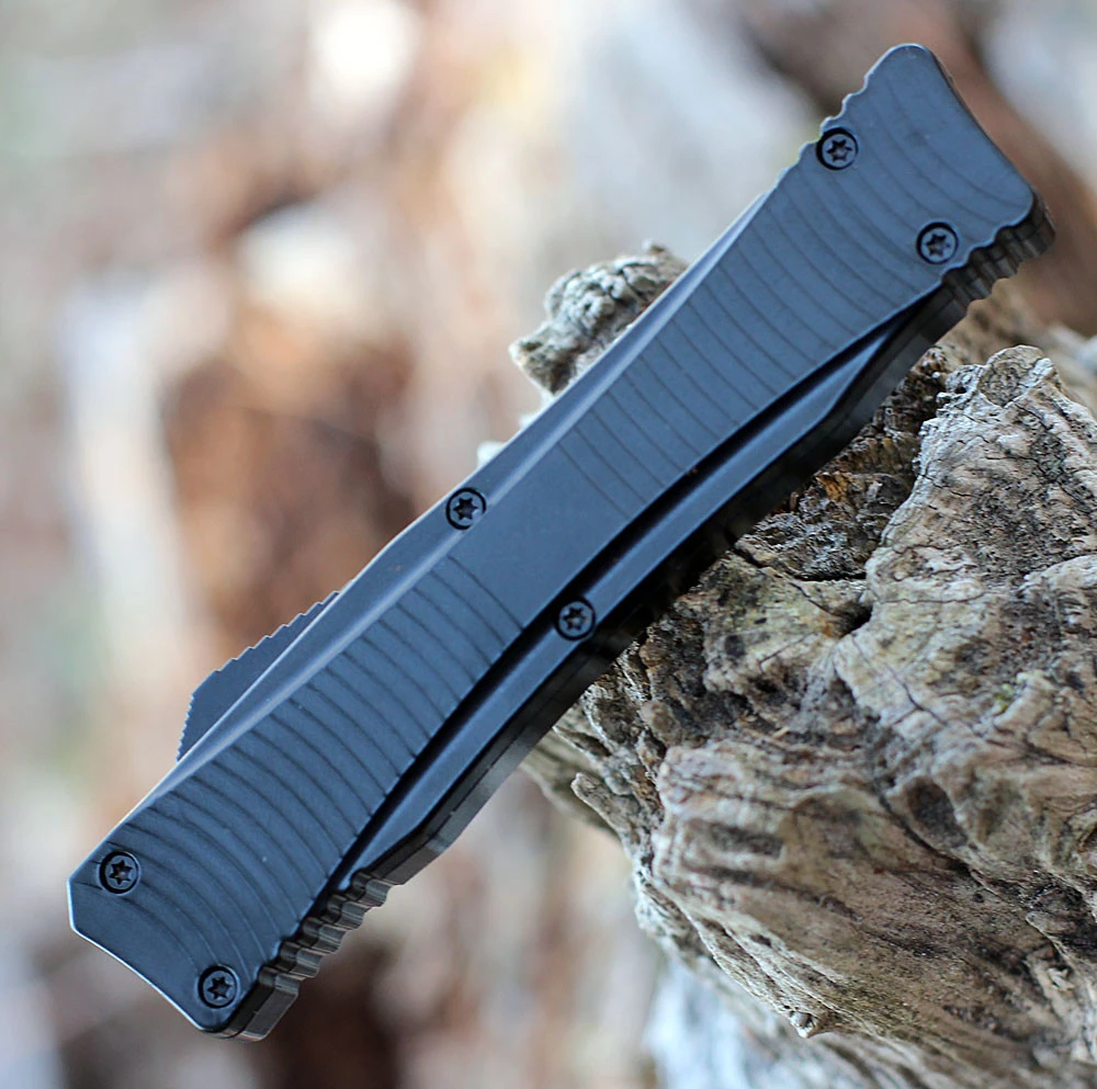 Boker Plus Falcon 2.0 OTF 06EX245 double-action OTF thumb slide close-up — spring-driven deployment, black aluminum, tip-down carry clip