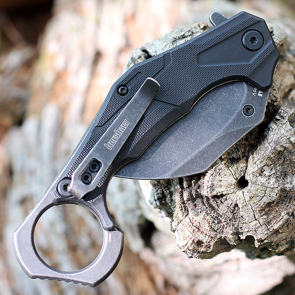 Kershaw 2064 Outlier highlighting the black GFN handle scales and integrated tactical finger ring.
