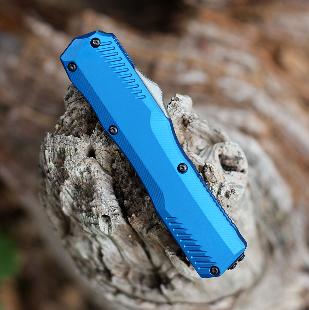 Close-up of the vibrant blue anodized aluminum handle and the staircase-style thumb slide on the Kershaw 9000BLU.
