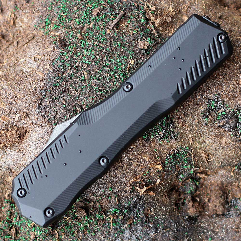 Detailed close-up of the black-anodized aluminum handle and the charcoal gray staircase-style thumb slide on the Kershaw 9000T.