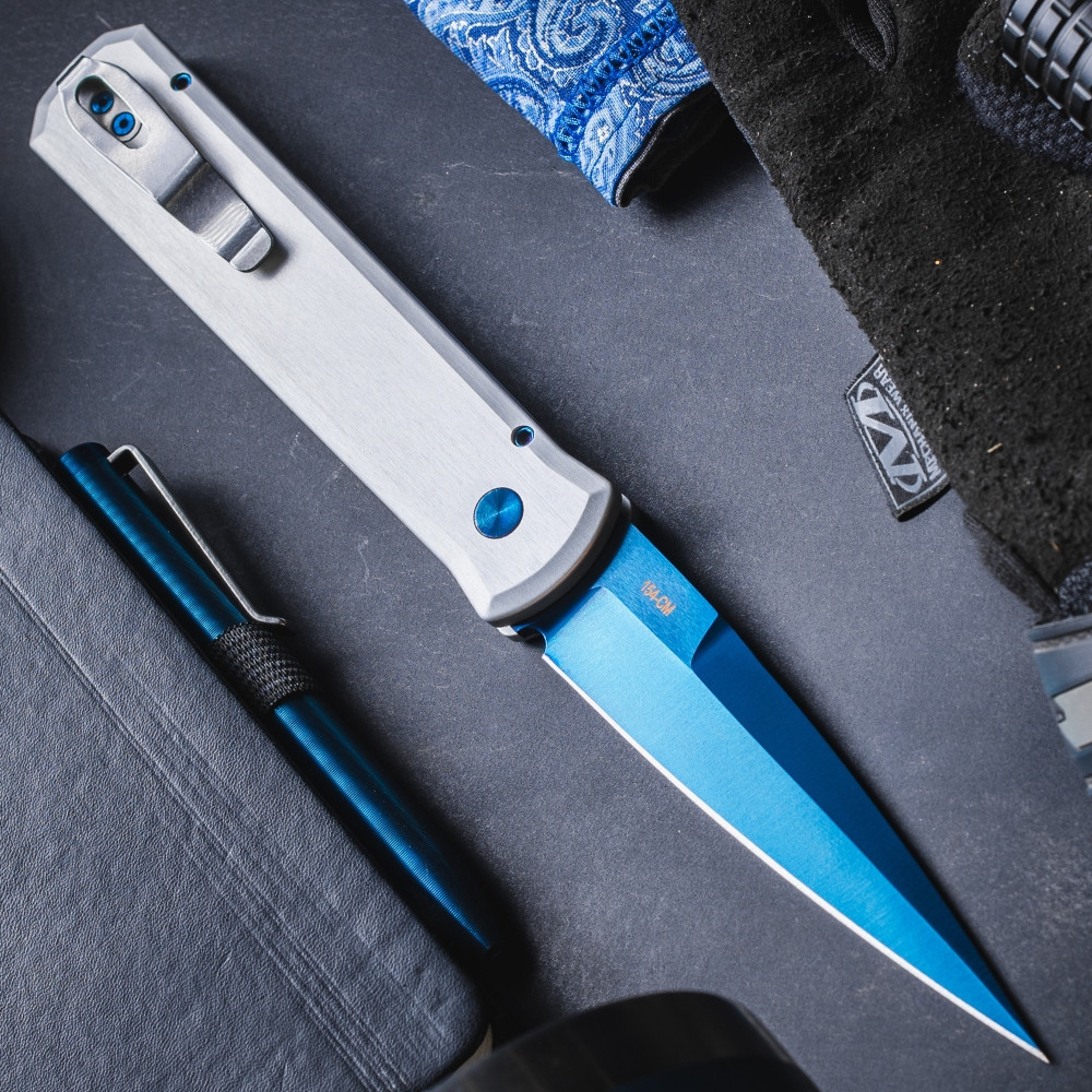 Pro-Tech Godfather BSA26.Godfather.2 shown deployed against a dark background, angled to display the full length of the knife. The sapphire blue PVD blade and satin silver aluminum handle are both clearly visible, with the stiletto profile of the Godfather frame shown in full.