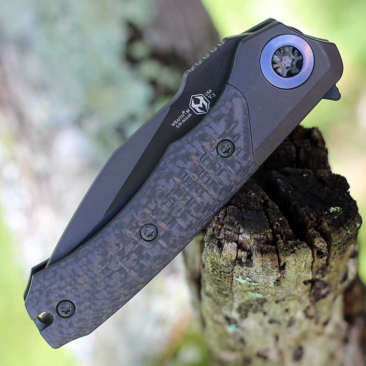 Heretic Knives Wraith Manual Flipper (H001-6B-BLUTI) 3.62" Magancut Clip Point Battleworn Black Part Serrated Blade, Titanium Chassis, Carbon Fiber Front Scale with Blue Titanium Accents, Battleworn Black Titanium Back