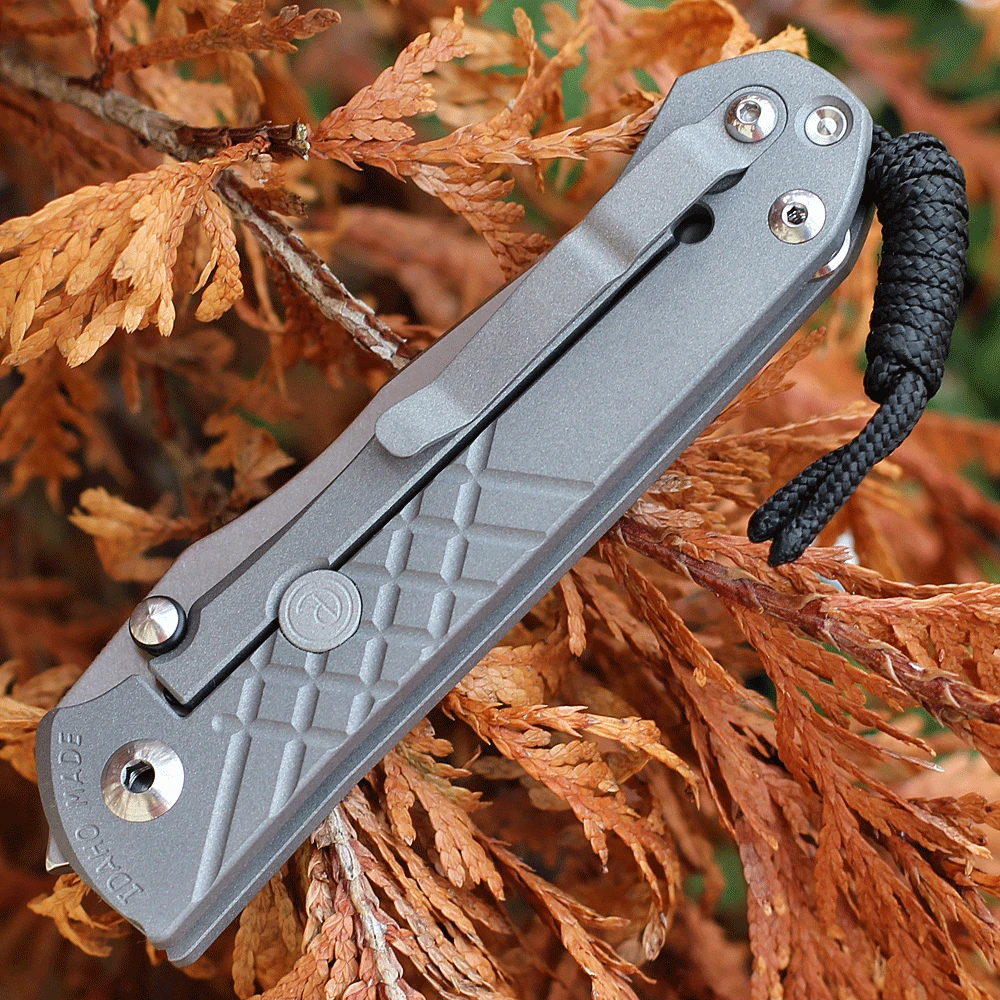 Chris Reeve Umnumzaan UMN-1014 glass blasted titanium close-up — fine-grained matte non-reflective texture, tactile grip vs natural titanium