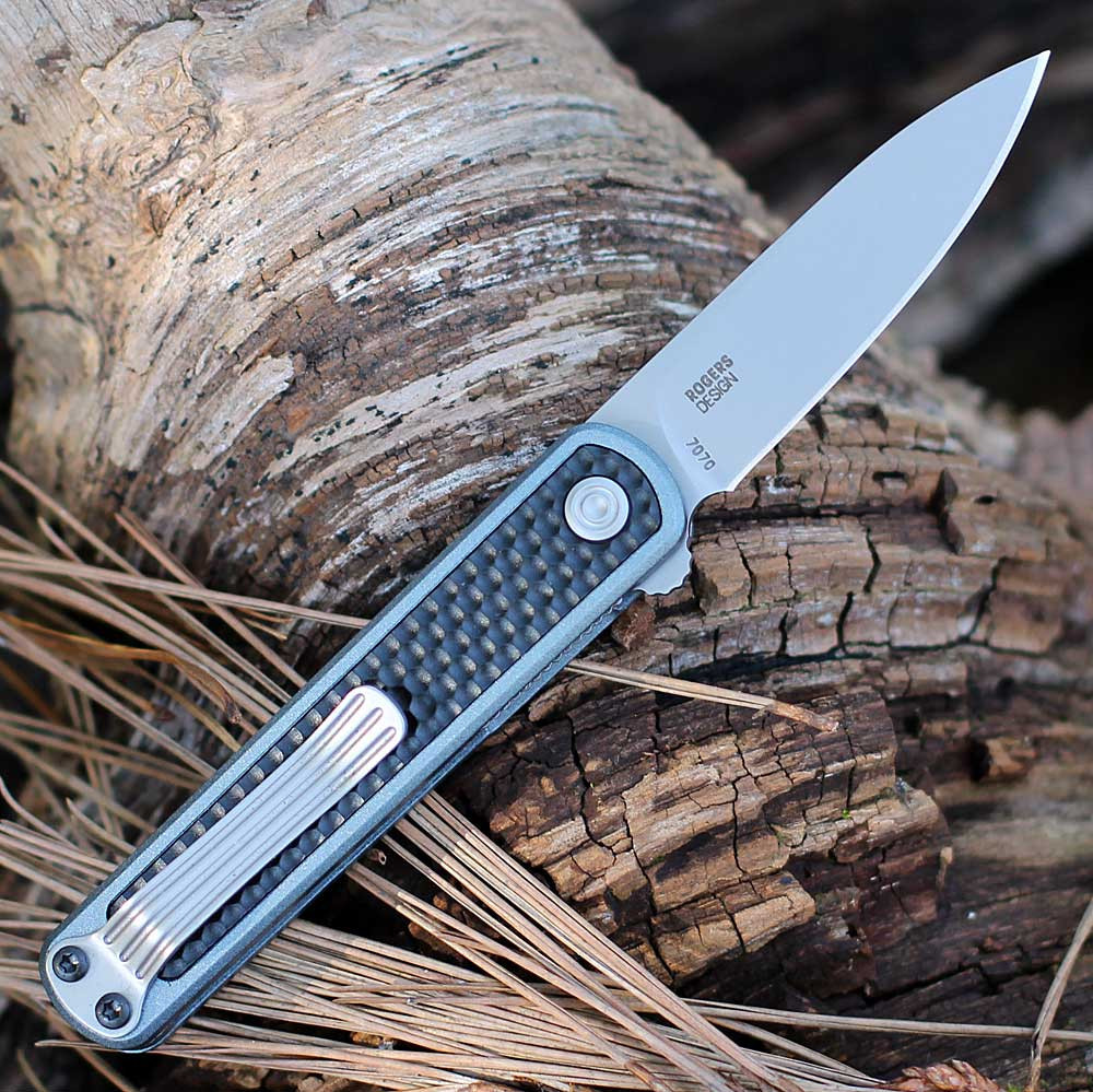 CRKT Pup 7070 profile view showing 2.09 inch AUS-10 bead blasted spear point blade and blue/black GRN handle.