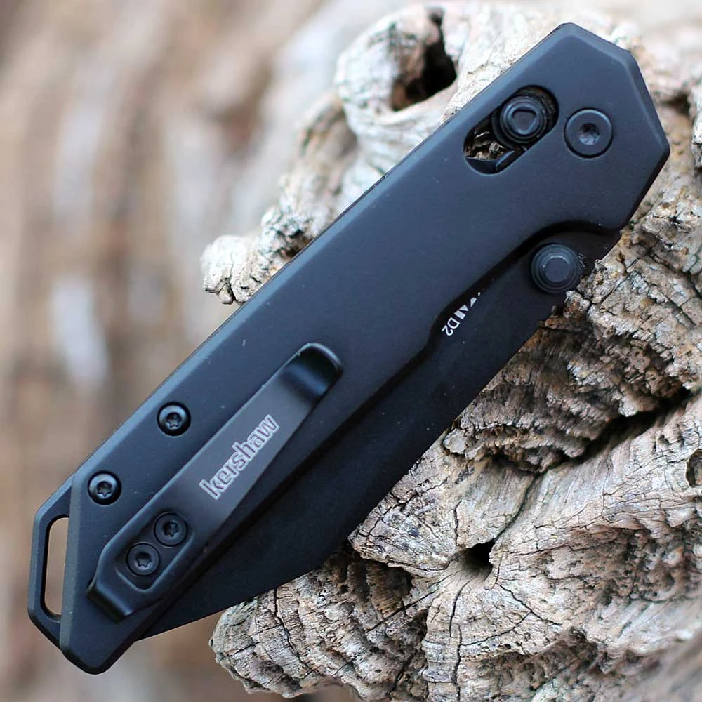 Detailed close-up of the DuraLock crossbar mechanism and black thumb studs on the Kershaw Mini Iridium.