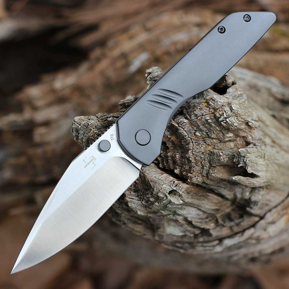 Boker Plus Max 01BO974 folding knife profile view showing CPM-S35VN satin blade and grey titanium handle.