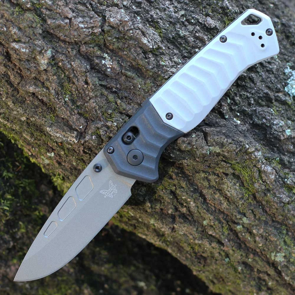 The Benchmade PSK (593GY-02) shown with its 3.45-inch Elmax drop point blade in a satin finish and hollow grind, storm gray Grivory handle scales, and its tip-up reversible pocket clip. The AXIS Assist thumb stud and AXIS Lock bar are visible along the spine of this spring-assisted EDC folder.
