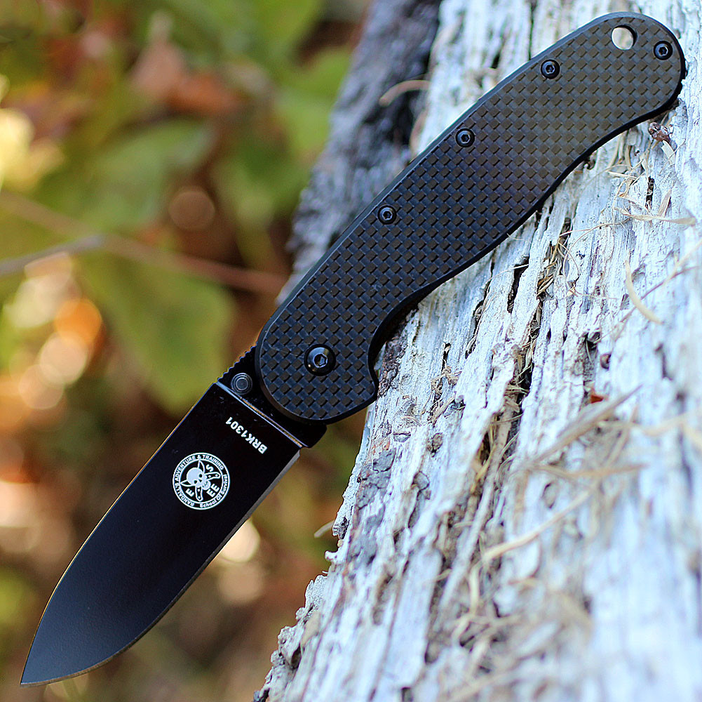 The ESEE Avispa (BRK1302CFB) shown with its 3.50-inch D2 drop point blade in a black finish and flat grind, black carbon fiber and G-10 handle with steel frame lock, and pocket clip for tip-up or tip-down carry.