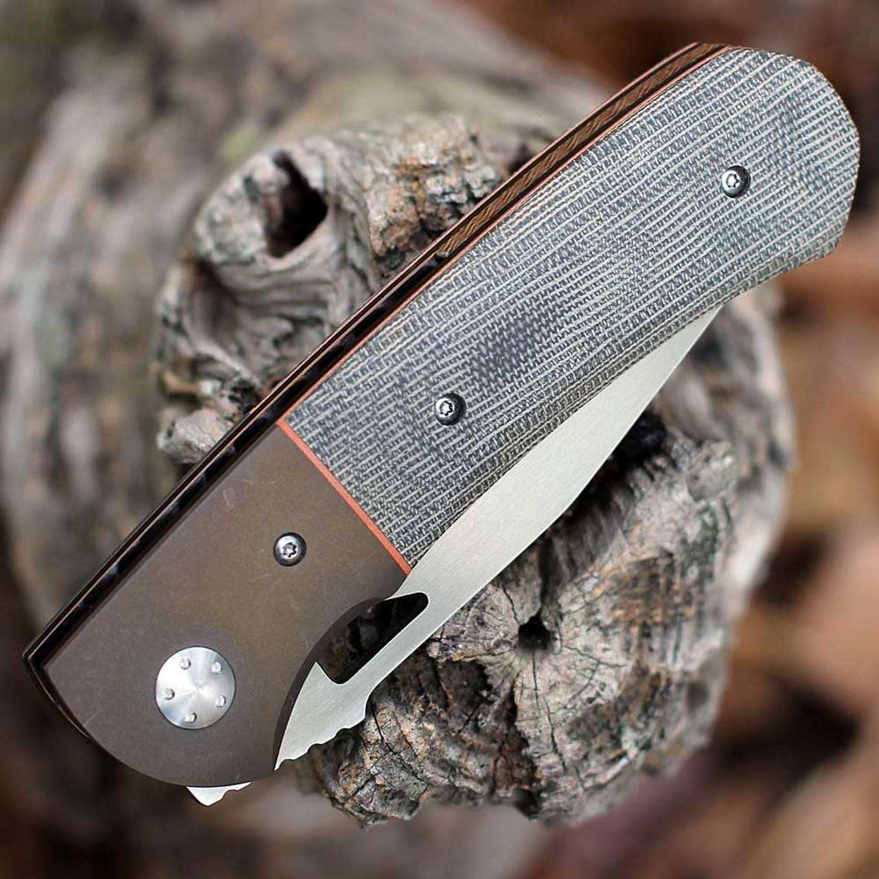Anodized titanium bolsters and contoured Canvas Micarta handle scales on Resistor