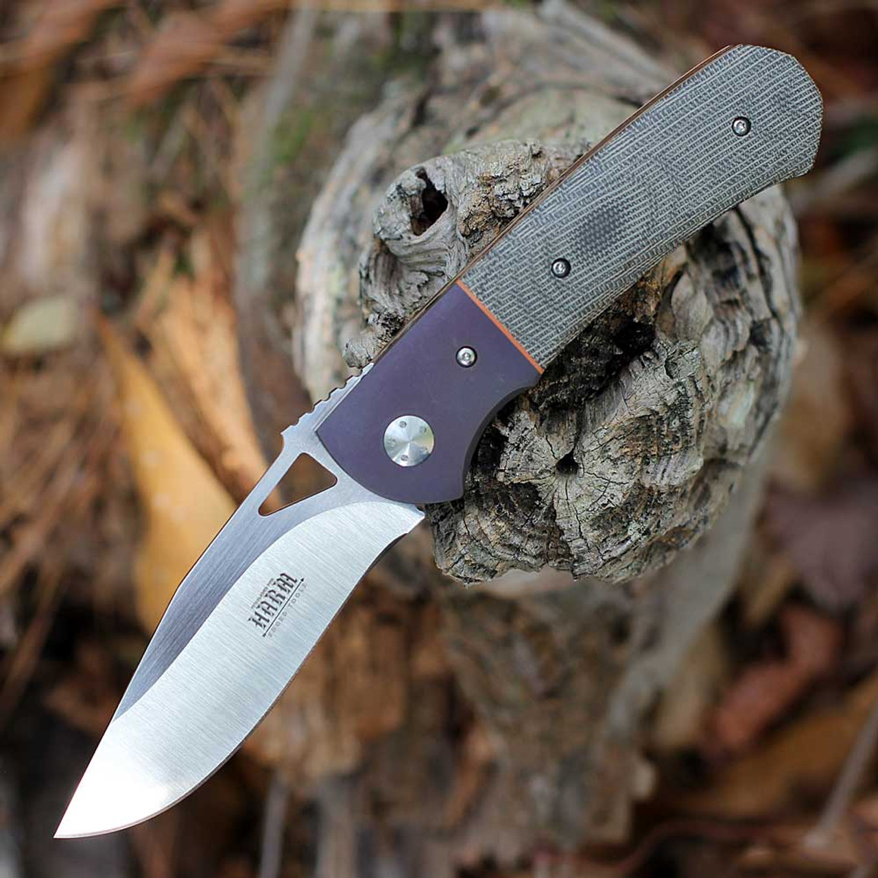 Linerlock folding knife with Canvas Micarta handle and titanium liners