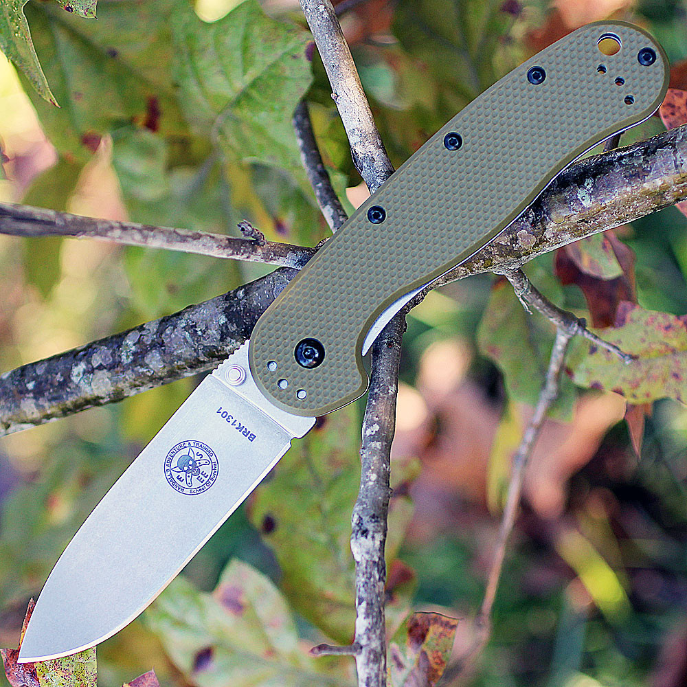 The ESEE Avispa (BRK1302OD) shown with its 3.50-inch D2 drop point blade in a stonewash finish and flat grind, OD Green polymer handle with steel frame lock, and pocket clip for tip-up or tip-down carry.
