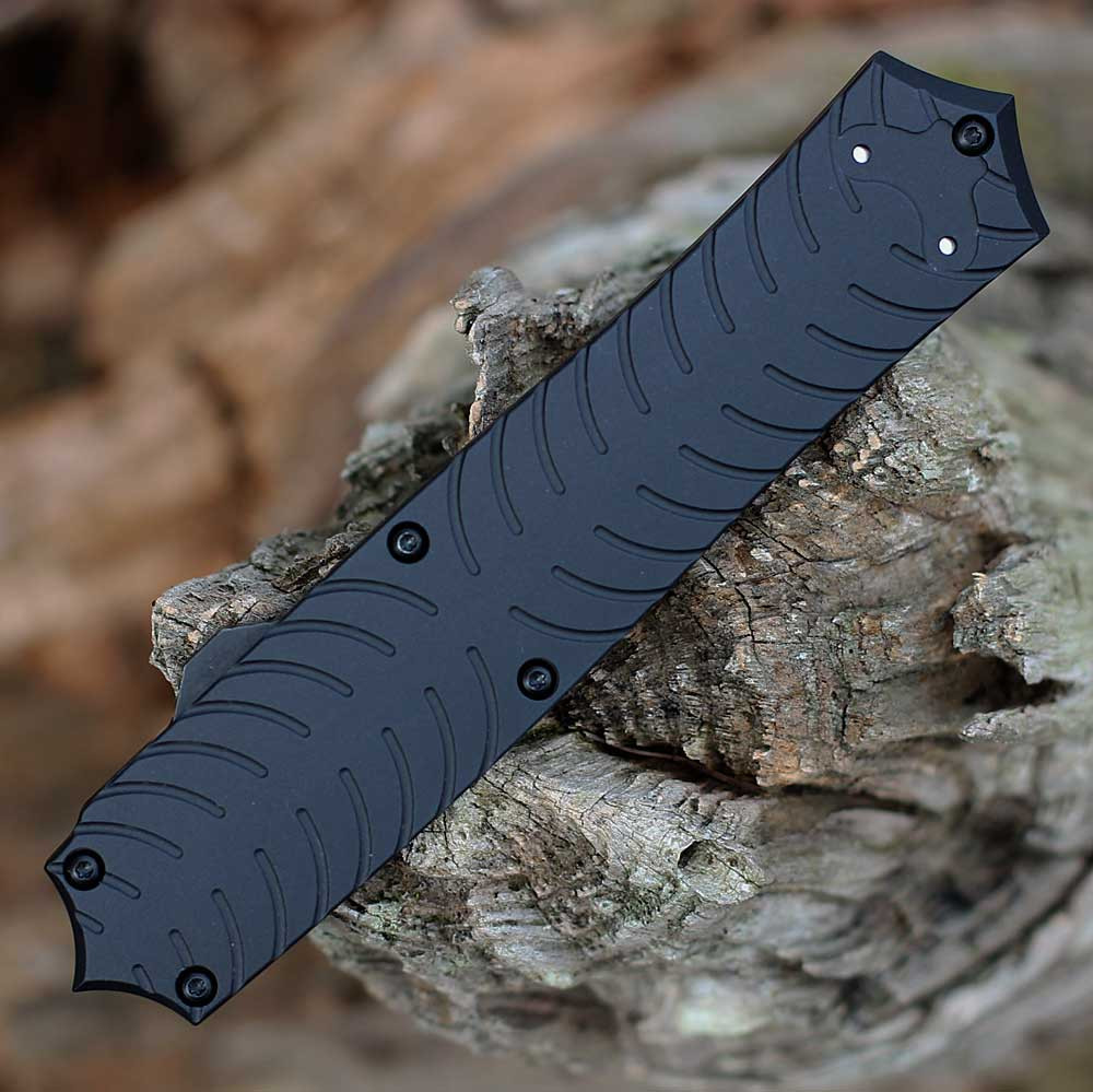CRKT Xolotl OTF Auto 5335 profile view showing 3.50 inch MagnaCut black double-edge dagger blade and sculpted black aluminum handle.