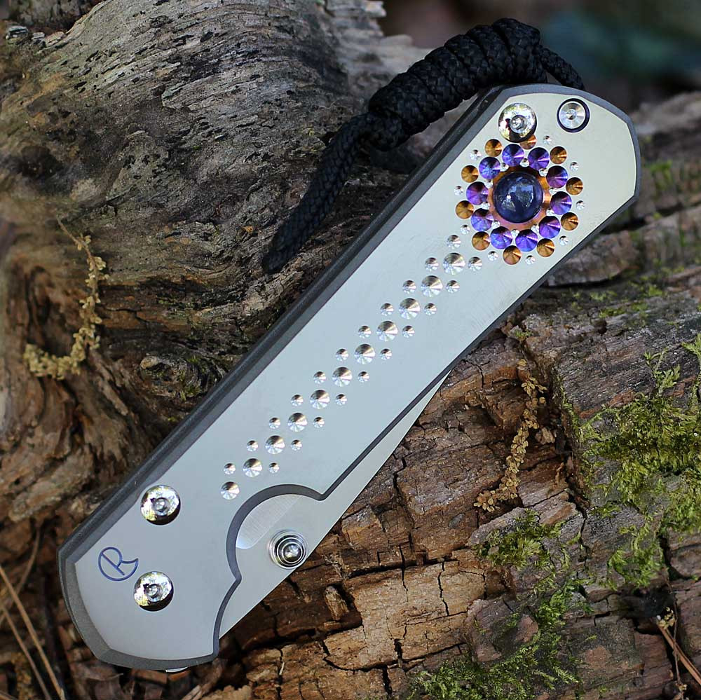 Chris Reeve Sebenza 31 showing the Unique Graphic titanium handle and silver hardware.