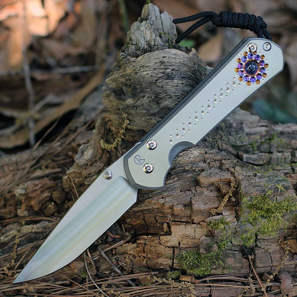 Chris Reeve Large Sebenza 31 Unique Graphic L31-1408-0532 showing the Iolite Cabochon thumb stud.