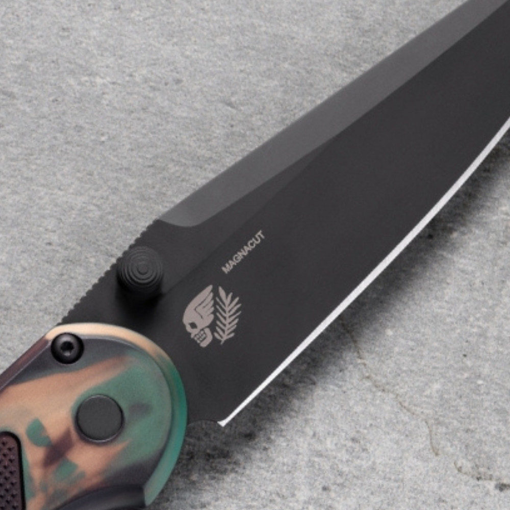 Pro-Tech Avalon PN1103-SHIPWRECK shown at an angle on a gray concrete surface, highlighting the spine and clip side of the knife. The black deep-carry pocket clip, black thumb studs, and the Shipwreck multicolor aluminum handle finish are visible from this perspective.