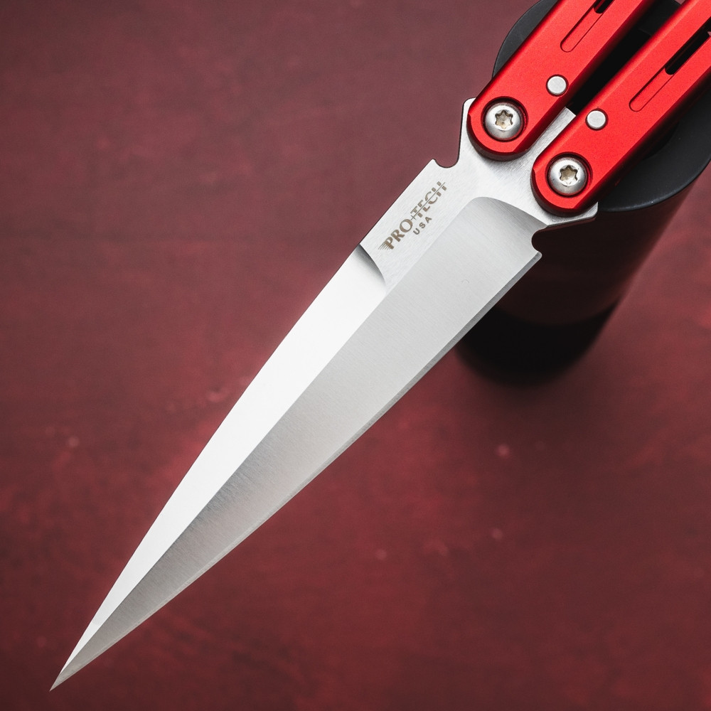 Pro-Tech Flyfather 2 FF2101-RED shown in a mid-deployment position against a dark red background, with the handles partially open and the satin 154CM blade visible between the red aluminum channel handles. The bushing pivot and zen pin construction are visible at the handle joints.